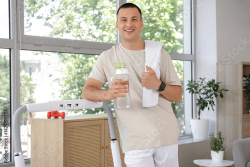 Sporty young man with towel...