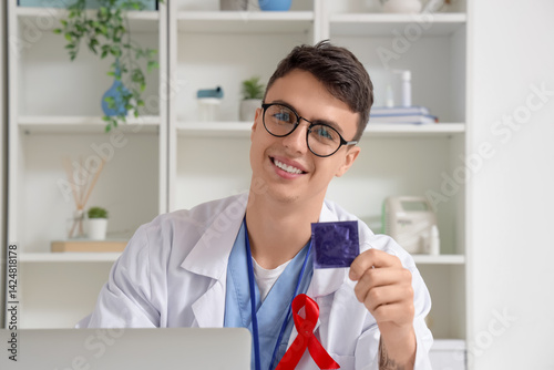 Young doctor showing condom...