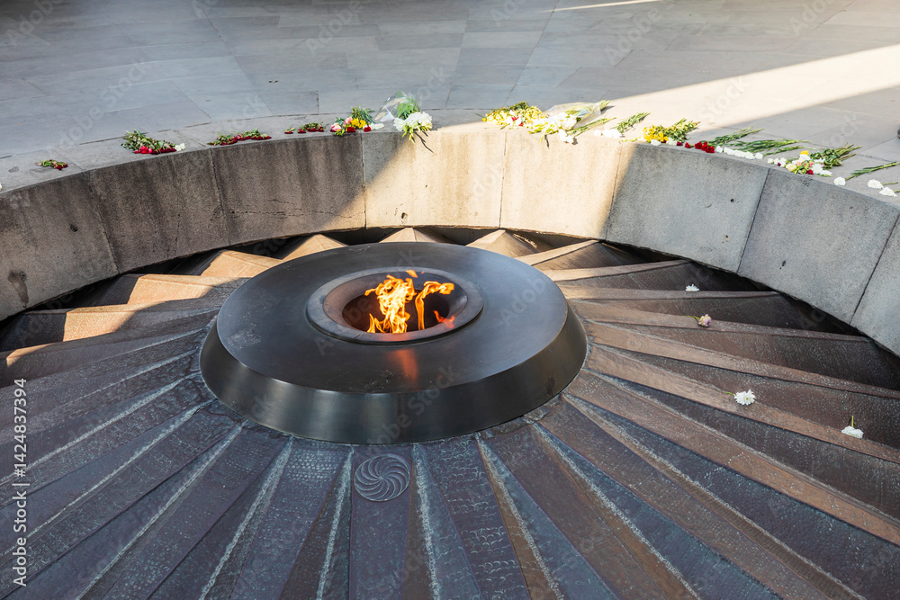 Yerevan, Yerevan Province, Armenia. The eternal flame with flowers, in the Memorial Hall at the Tsitsernakaberd Armenian Genocide Memorial Complex.