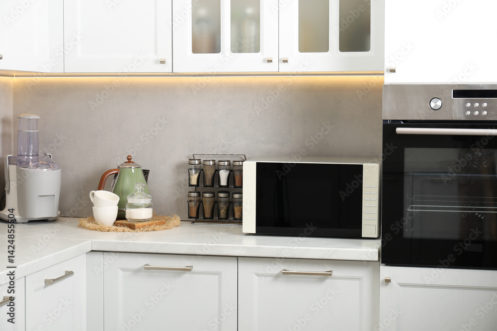 Closed microwave oven on counter in kitchen Closed microwave oven on counter in kitchen