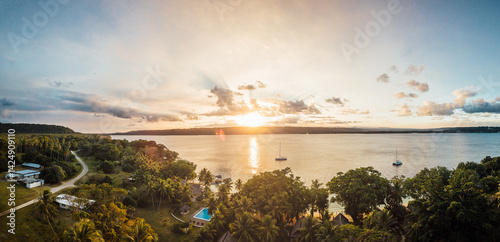 Stunning sunset over Aore island revealing serene waters and lush greenery in Vanuatu's South Pacific