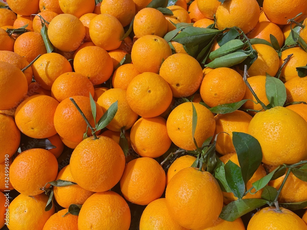 Closeup of heap of ripe orange placed on stall in local grocery market