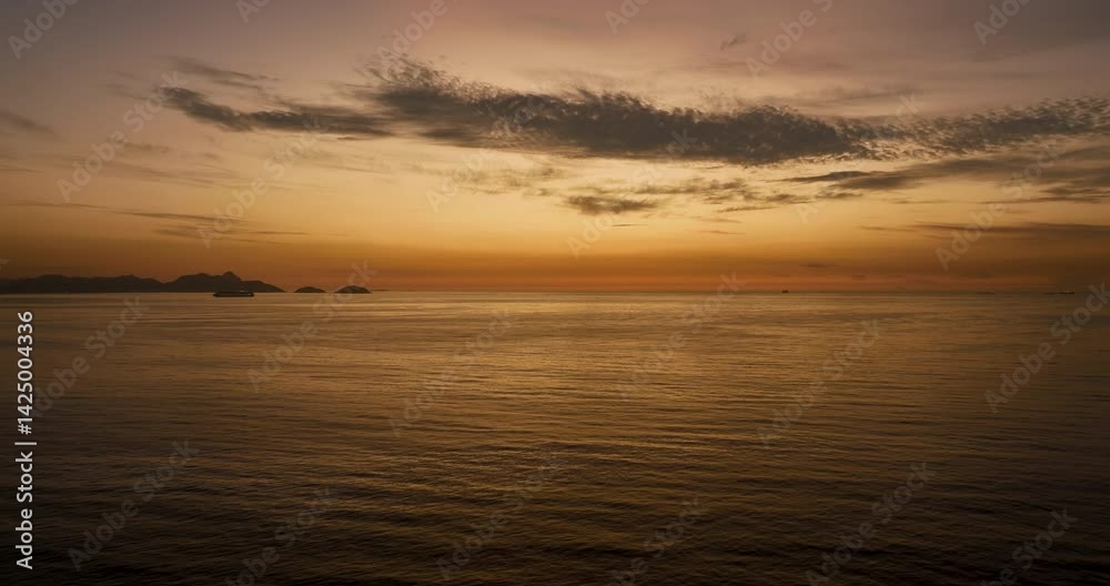 Flying above ocean towards sunrise. Dawn with the first sight of lightness in the morning