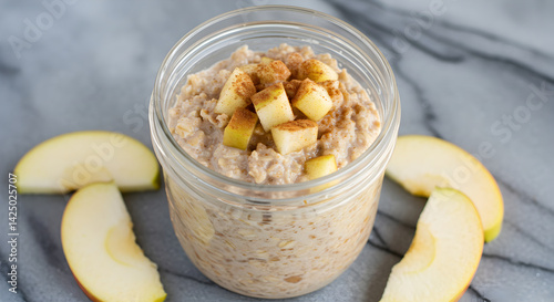 Overnight Oats Topped with Fresh Apples and Cinnamon in Glass Jar