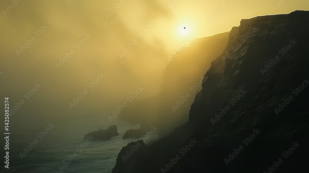 Golden mist shrouds dramatic coastal cliffs. Golden mist shrouds dramatic coastal cliffs.