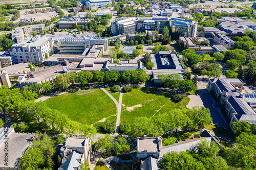View of a college campus with a large green field in the center
