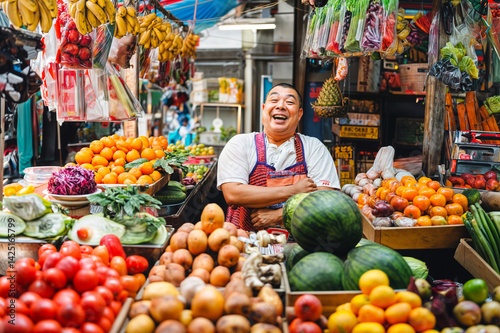 Obraz na płótnie A smiling man stands behind a vibrant fruit and vegetable stand, filled with a variety of colorful produce including bananas, oranges, watermelons, tomatoes, and more w salonie
