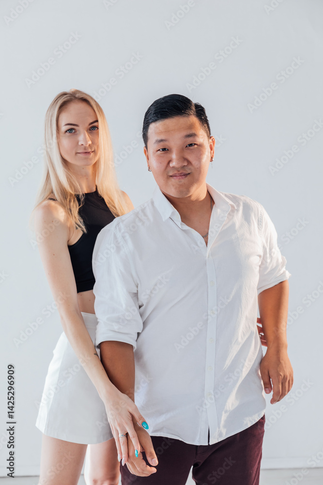man and blonde woman smiling and hugging together on white background man and blonde woman smiling and hugging together on white background