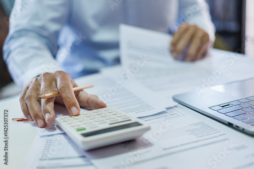 close up shot, accountants working in office use calculators to calculate business costs, profits and tax