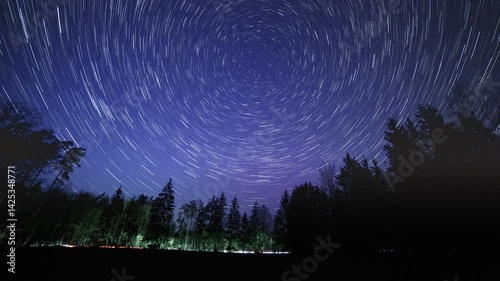 Night sky 4k time lapse with star trails over forest. Abstract time lapse with startrails.