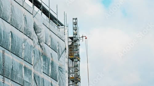 Industrial Scaffolding Secured with Safety Net Tarp at Multi Storey Residetial Building Construction Site