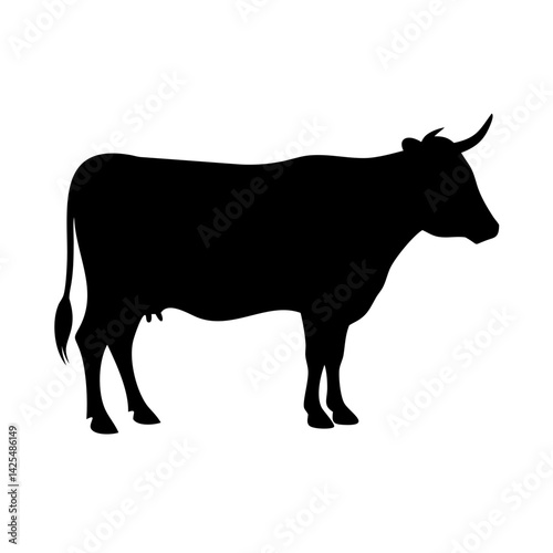 Silhouette of a cow standing in a pastoral landscape during daylight showcasing rural life and agriculture