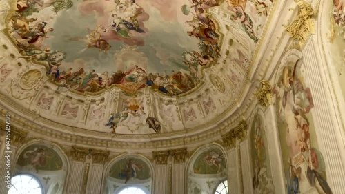 Ornate painted ceiling and walls with floral motifs and decorative gold accents in the garden pavilion of Melk Abbey. Melk, Austria. Europe.