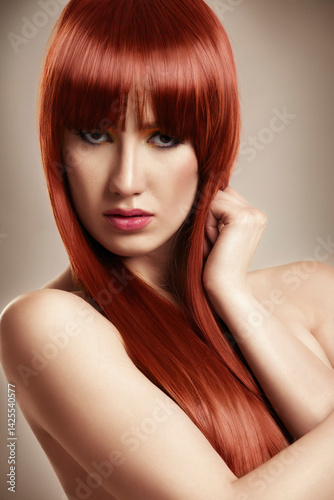 Beautiful young model with red long hair