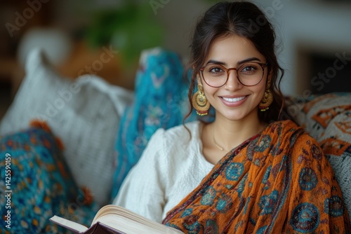 Indian woman relaxed on a cozy couch with a good book photo