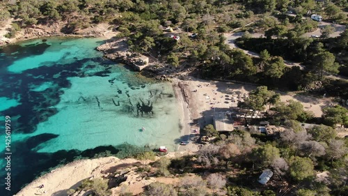 Mallorca beach resort . Aerial view of the of the beach shore, turquoise waters, white sand umbrellas and restaurants and hotels convey a holiday summer feeling