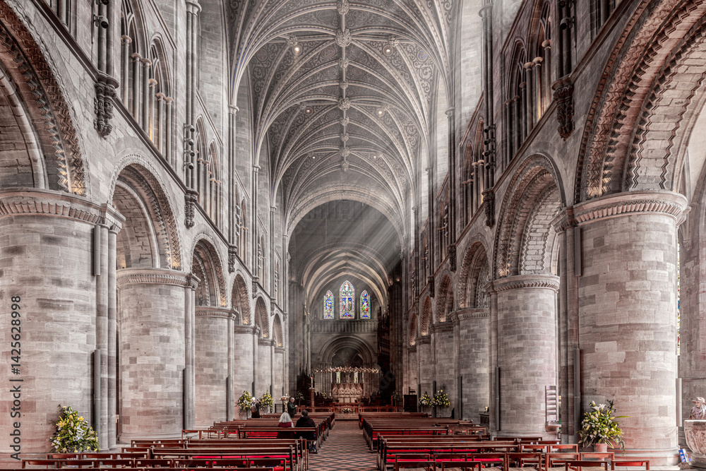 The interior of Hereford Cathedral, Herefordshire, England UK. The sun beams are visible in the incense smoke of the Easter Sunday morning service.