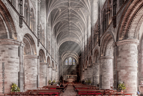 Obraz na płótnie The interior of Hereford Cathedral, Herefordshire, England UK. The sun beams are visible in the incense smoke of the Easter Sunday morning service. w salonie