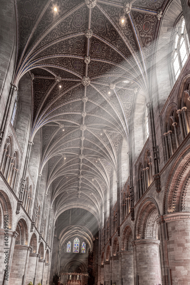 The interior of Hereford Cathedral, Herefordshire, England UK. The sun beams are visible in the incense smoke of the Easter Sunday morning service.