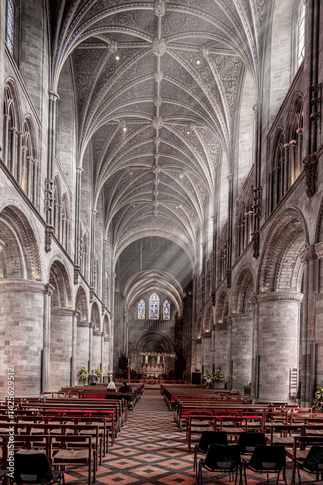 The interior of Hereford Cathedral, Herefordshire, England UK. The sun beams are visible in the incense smoke of the Easter Sunday morning service.