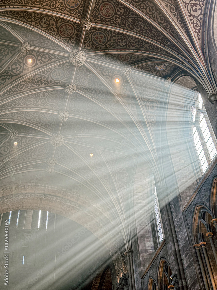 The vaulted ceiling of Hereford Cathedral, Herefordshire, England UK. The sun beams are visible in the incense smoke of the Easter Sunday morning service.