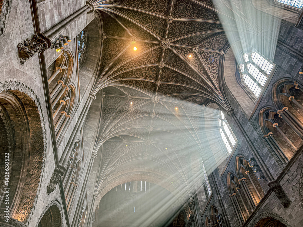 The vaulted ceiling of Hereford Cathedral, Herefordshire, England UK. The sun beams are visible in the incense smoke of the Easter Sunday morning service.