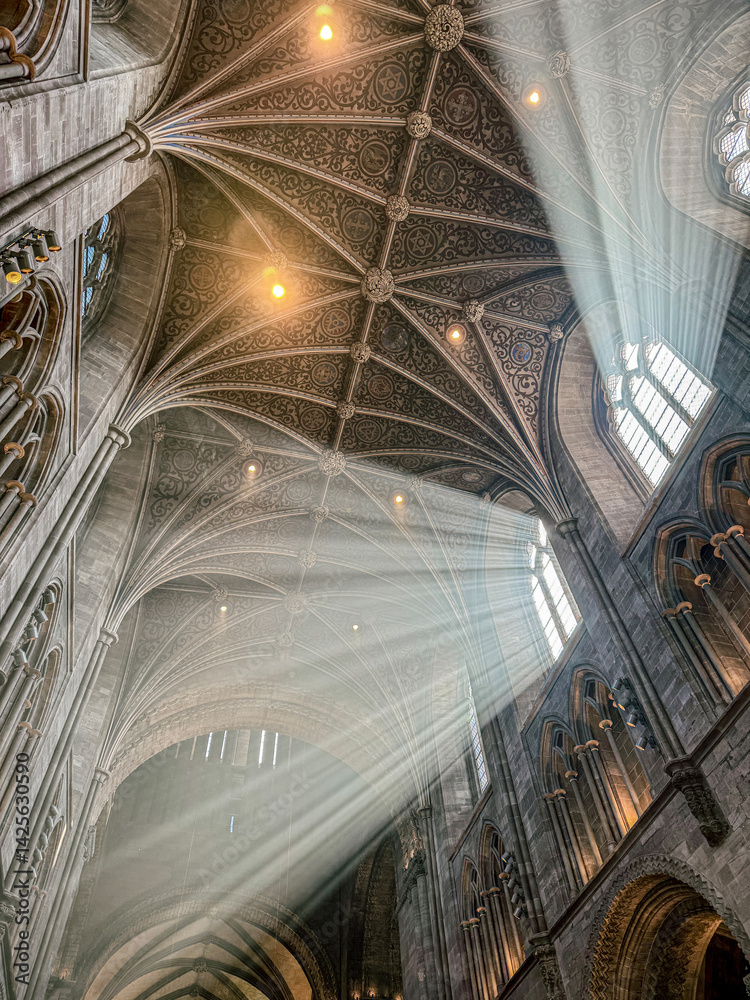 The vaulted ceiling of Hereford Cathedral, Herefordshire, England UK. The sun beams are visible in the incense smoke of the Easter Sunday morning service.