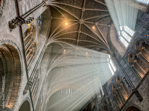 Obraz na płótnie The vaulted ceiling of Hereford Cathedral, Herefordshire, England UK. The sun beams are visible in the incense smoke of the Easter Sunday morning service. w salonie