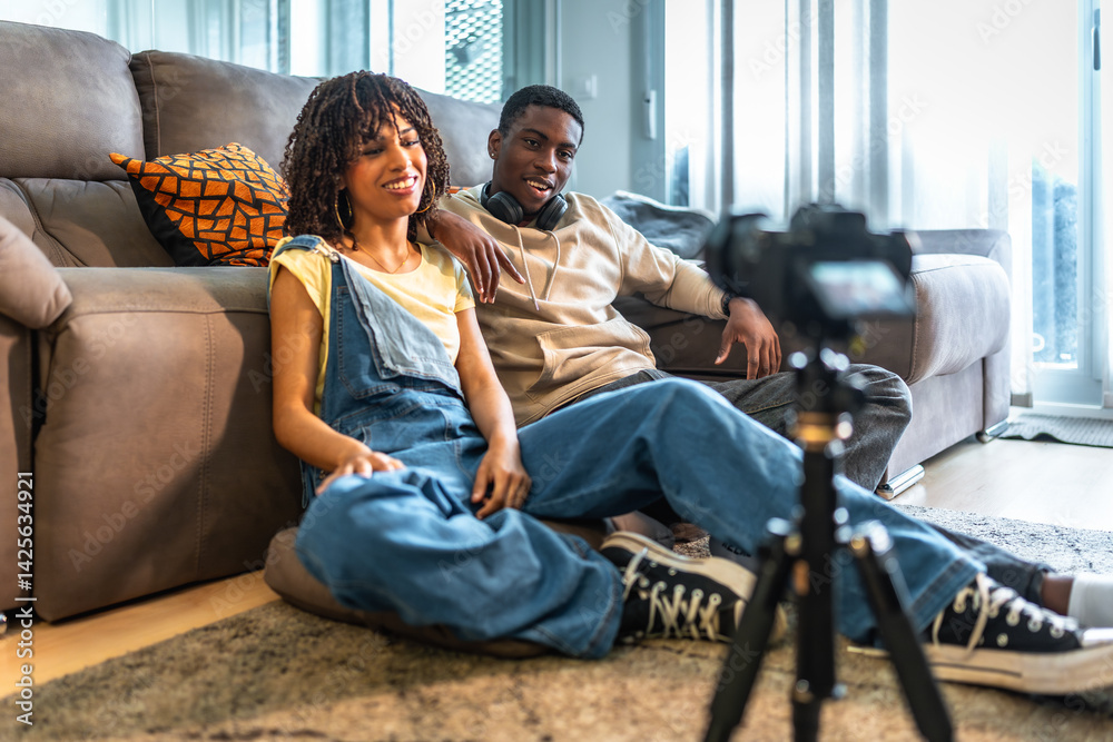 Young black couple recording video content at home
