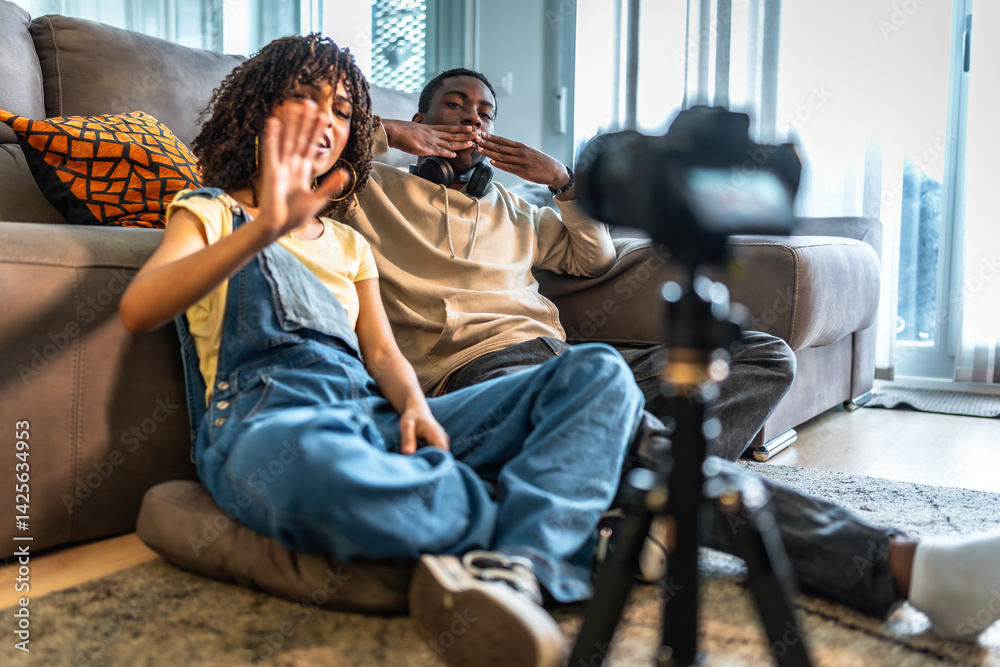 Content creators recording a video blog from home sitting on the floor