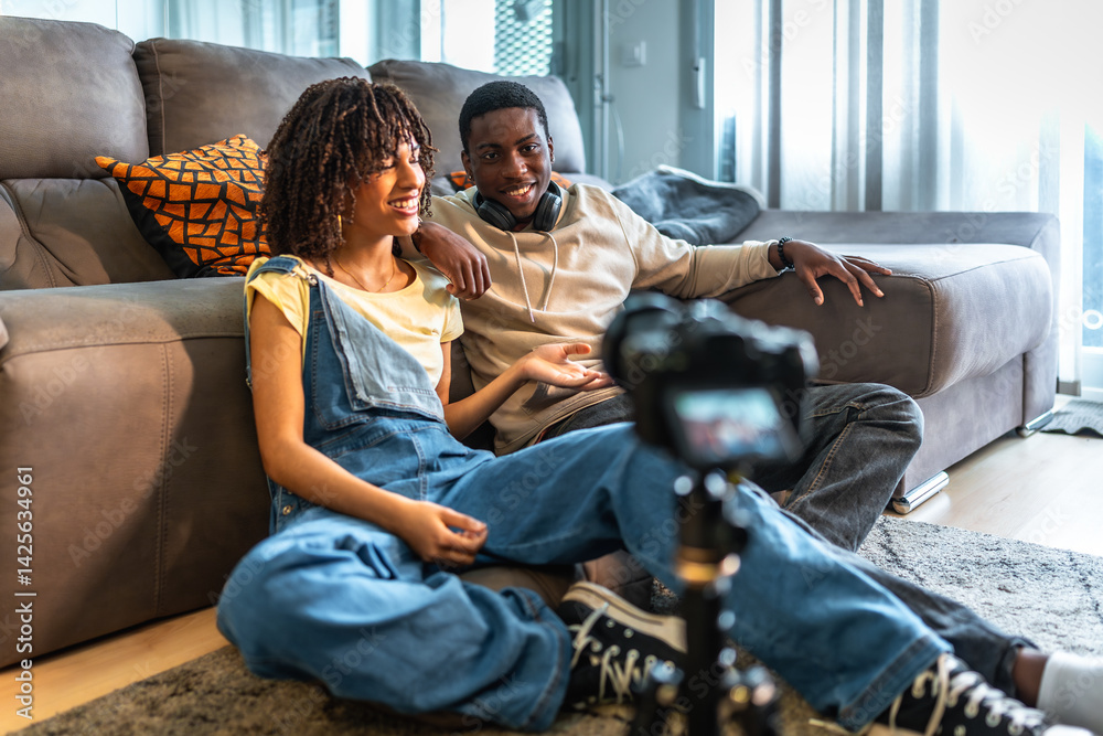 Young black couple recording a video blog at home