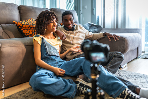Obraz na płótnie Young black couple recording a video blog at home w salonie