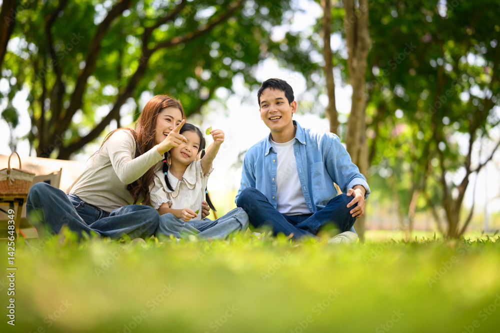 Happy family enjoying time together in nature during a sunny day picnic Happy family enjoying time together in nature during a sunny day picnic