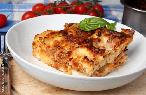 Portion of lasagna bolognese on a plate.