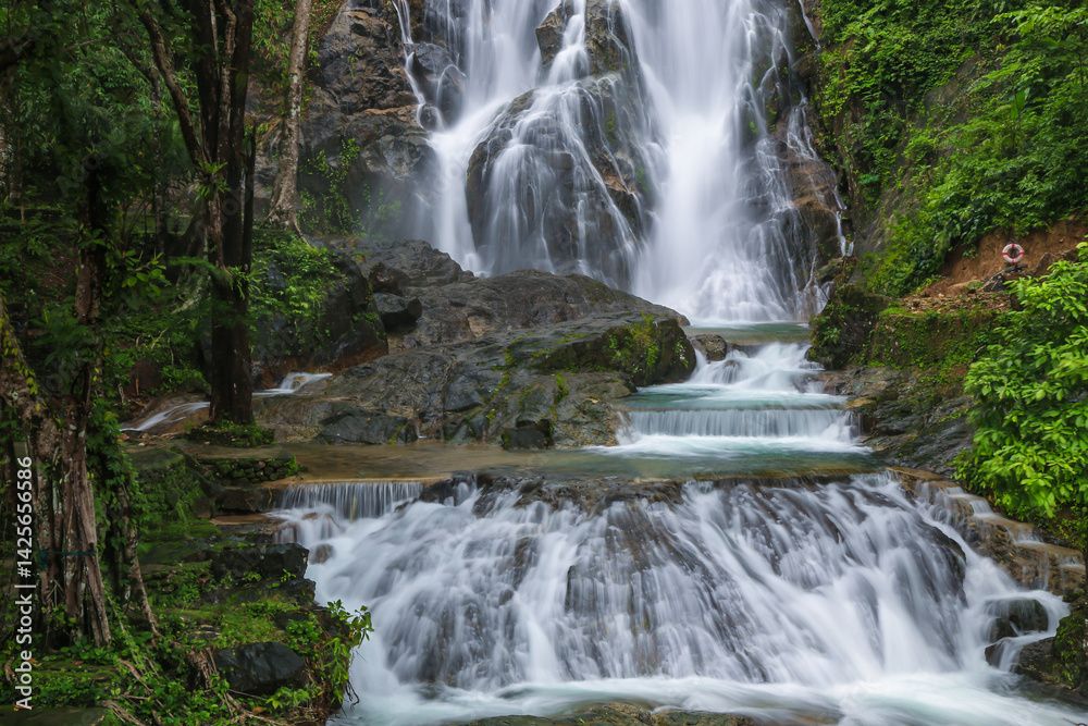 Fototapeta premium Punyaban Waterfall is a waterfall with water flowing all year round, located on Phetkasem Road, 2 kilometers from the National Park Office. It has 3 levels and is located in Mueang District, Ranong