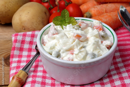 Bowl with a portion of Russian salad.