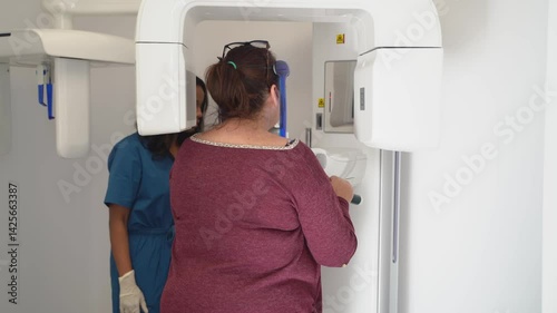 Patient undergoing dental panoramic radiography