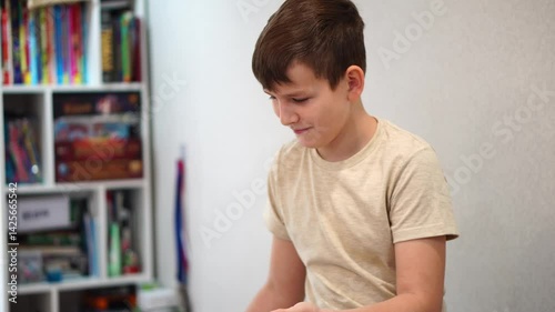 Teenage boy tosses a coin to determine heads or tails and drops the coin