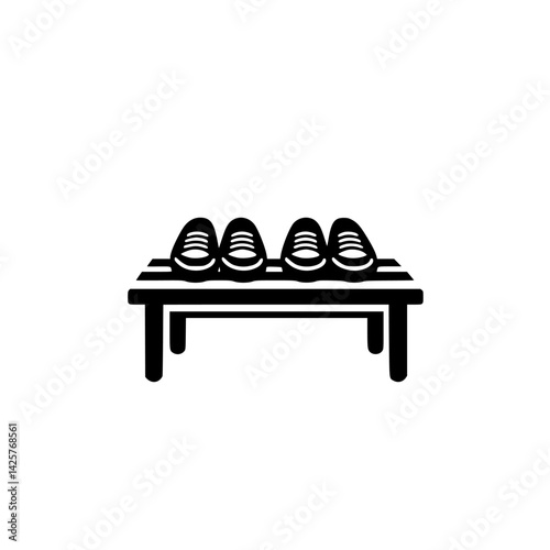 Three pairs of black shoes neatly arranged on a wooden display table