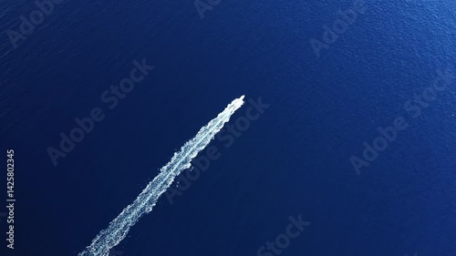 A tourist boat sails through the Calanques de Piana, in Europe, in France, in Corsica, towards Ajaccio, on the edge of the Mediterranean Sea, in summer, on a sunny day. 