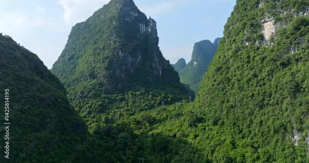 Aerial view rising in middle of karst mountains, sunny day in Yangshuo, China Aerial view rising in middle of karst mountains, sunny day in Yangshuo, China