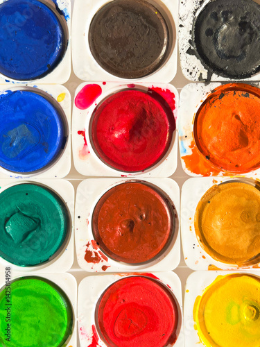 Set of watercolor paints and paintbrushes for painting closeup. Selective focus.