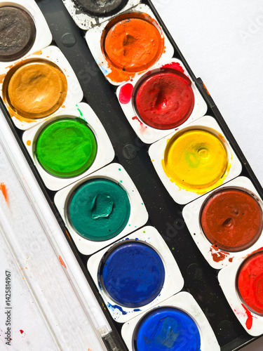 Top view of watercolor paints in box isolated on white background with clipping path