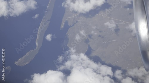 Aerial view revealing scenic coastline, soaring above clouds and croatian islands with expansive blue sky and peaceful horizon