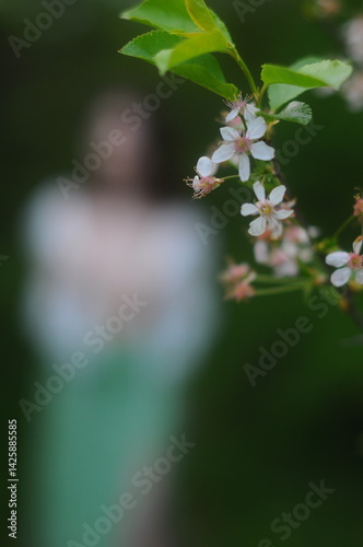 young girl walking in a summer park in a white blouse and skirt