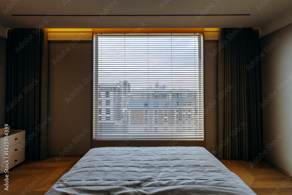 Fototapeta premium Cozy bedroom with a bed and a window featuring decorative blinds