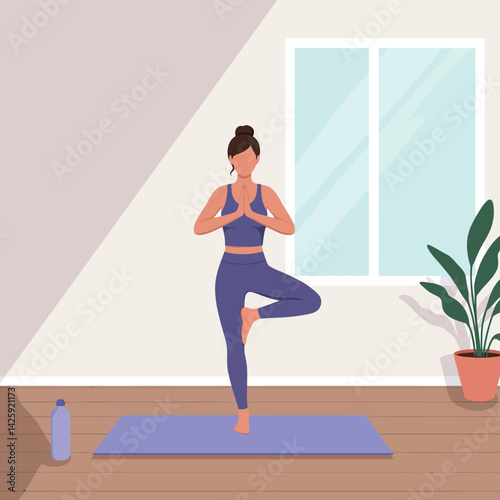 Woman practicing tree pose yoga in modern room with green plant and blue mat