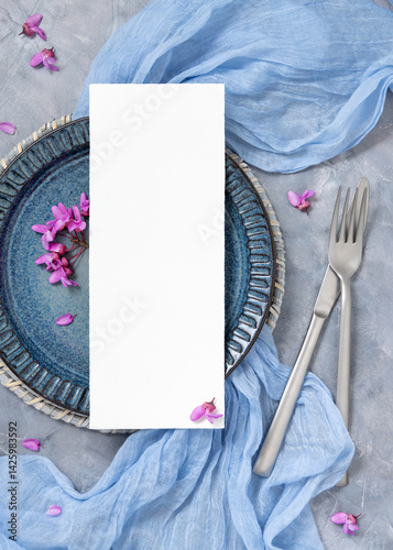 Obraz na płótnie Wedding table place with a card near fabric and wild purple flowers top view on gray, spring mockup w salonie