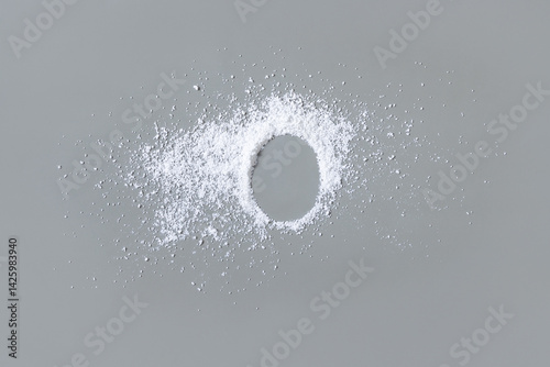 Obraz na płótnie White powder on grey with copy space in middle top view. Dietary supplement or kitchen spice w salonie