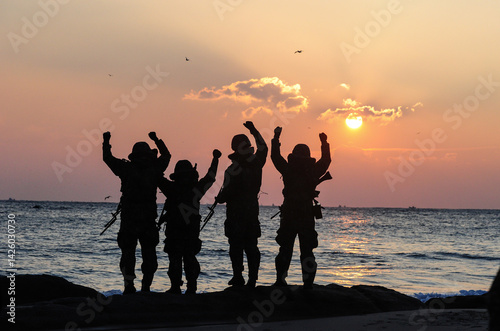 Silhouettes of Korean army soldiers looking at the sunrise